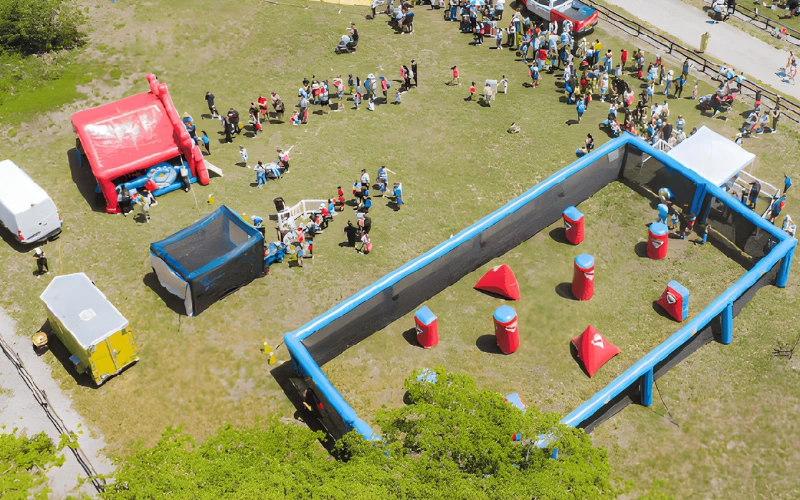 Large gellyball arena with inflatables at community event